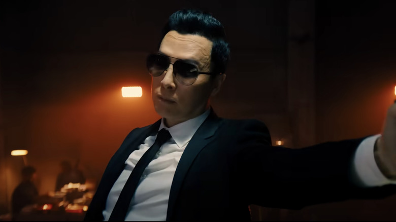 Caine reaching out during a fight