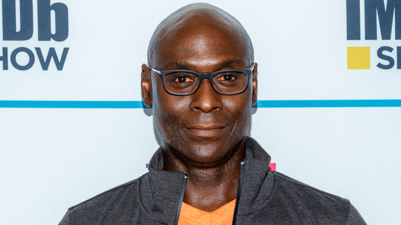 Lance Reddick at event smiling