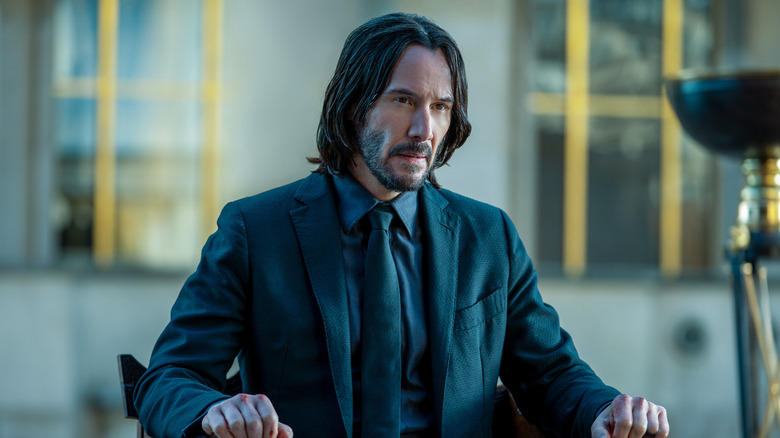 John Wick seated at table