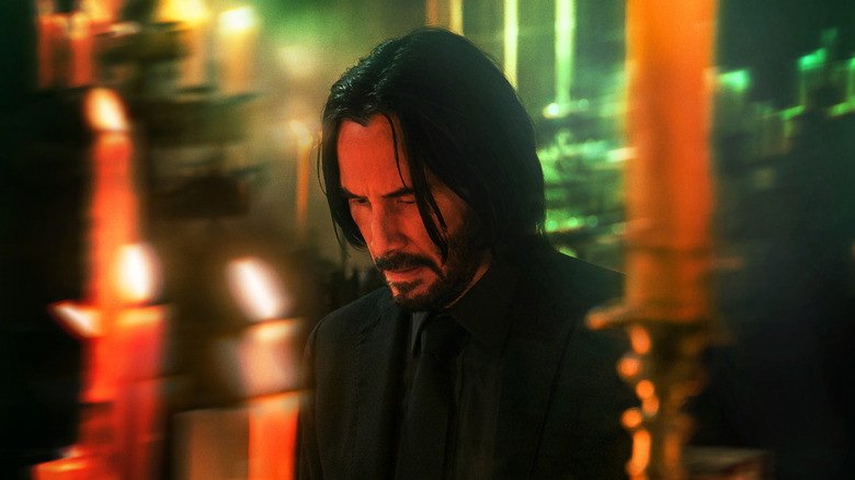 John Wick surrounded by candles