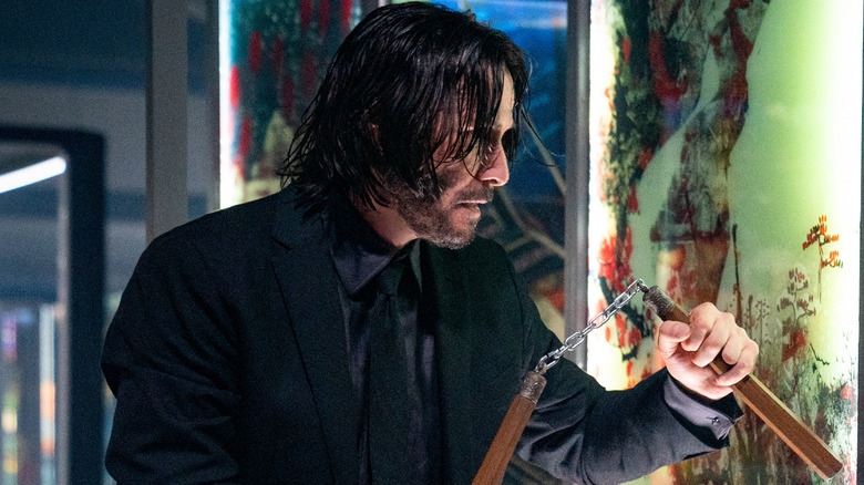 John Wick holding nunchucks