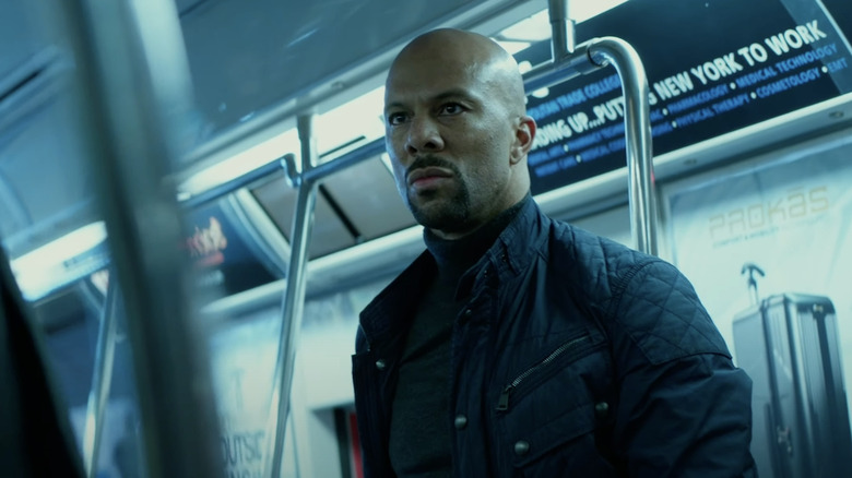 Cassian glares at a foe on the subway