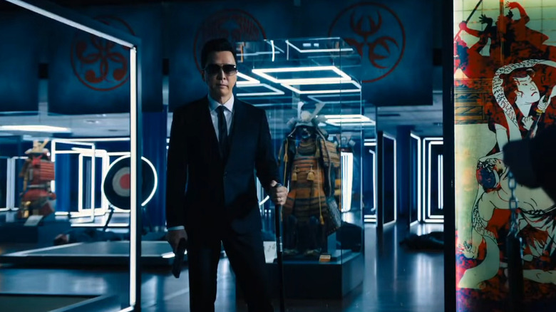 Caine holds his gun in the museum gallery in "John Wick: Chapter 4" (2023)
