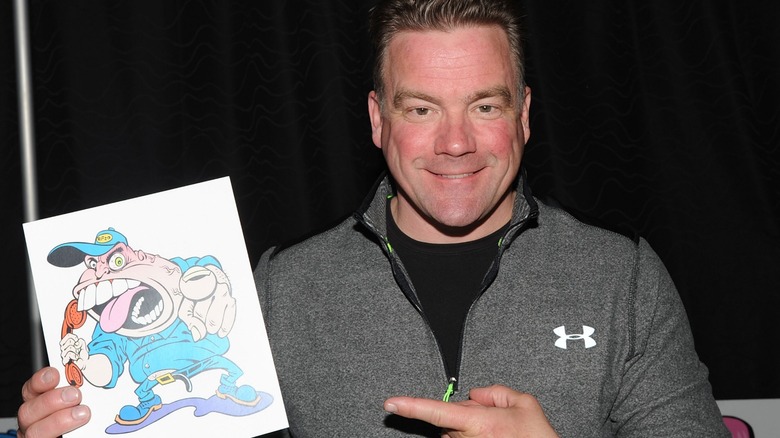 Johnny Brennan holding a Jerky Boys picture