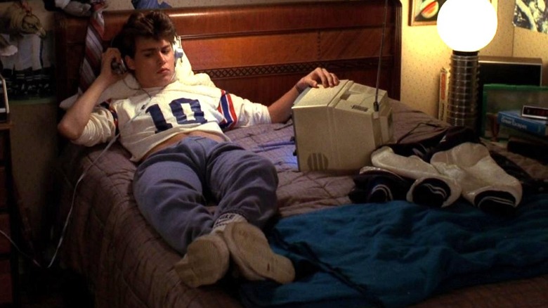 Glen Lantz sits on his bed while wearing headphones in 