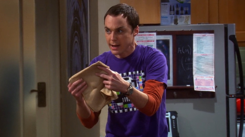 Sheldon excitedly holding a napkin