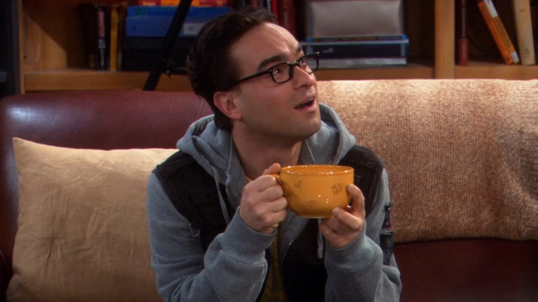Johnny Galecki holding mug and looking surprised