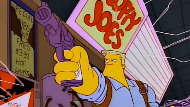 McBain pointing a gun