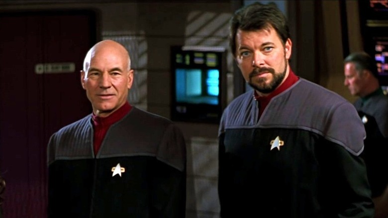 Picard stands next to Riker