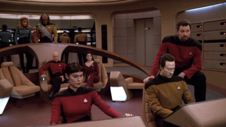 The bridge crew react to a situation on the viewscreen in Star Trek: The Next Generation