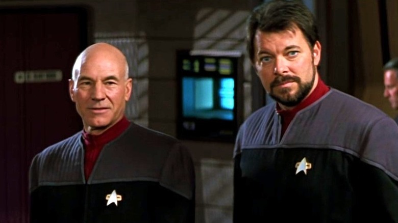 Picard stands next to Riker