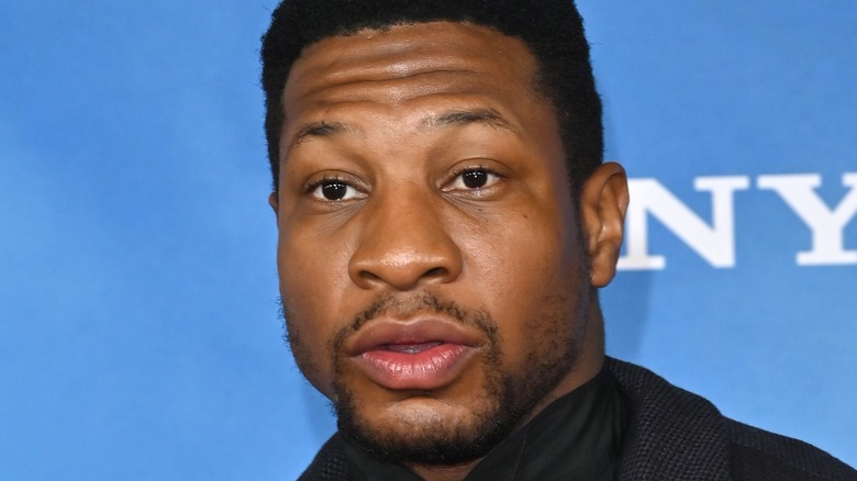 Jonathan Majors posing at premiere