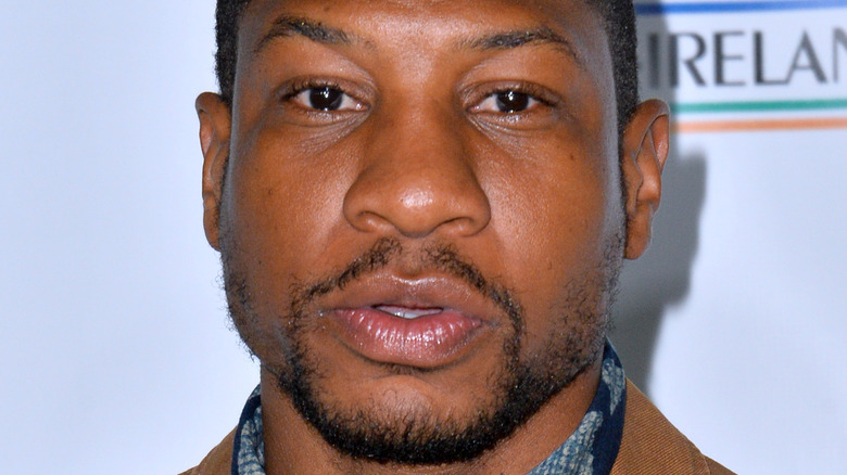 Jonathan Majors at event smiling