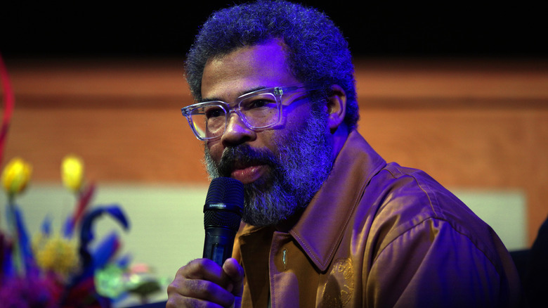 Jordan Peele speaking into microphone