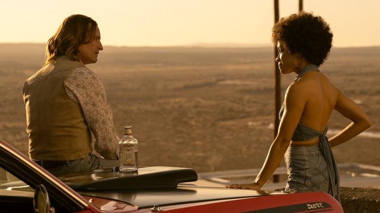 Jim talking to Nina at a scenic overlook in Duster (2025)