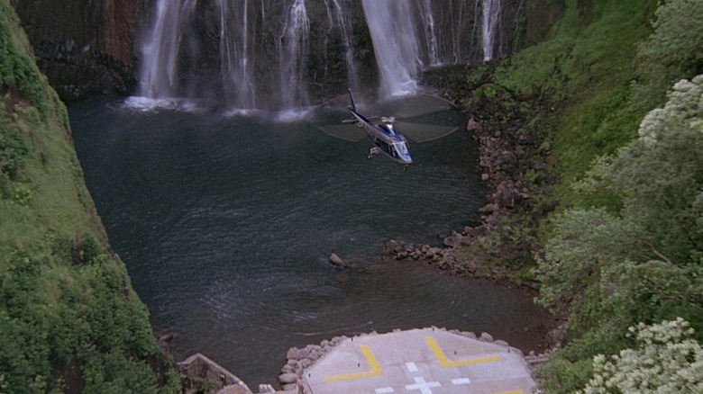 Helicopter landing near waterfall