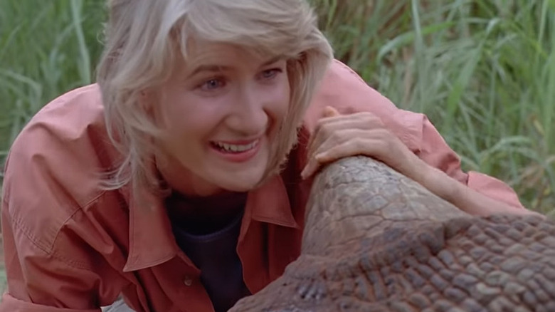 Ellie Sattler touching a dinosaur