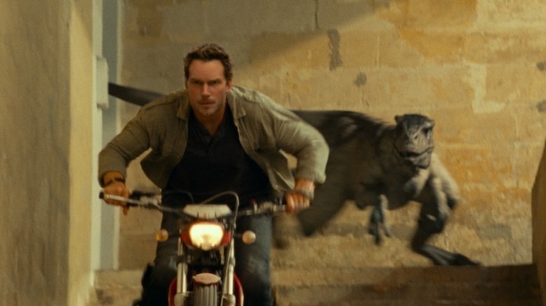 Owen riding bike chased by dinosaur