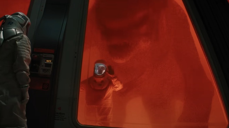 The D-Rex looms over an InGen scientist in "Jurassic World Rebirth" (2025)