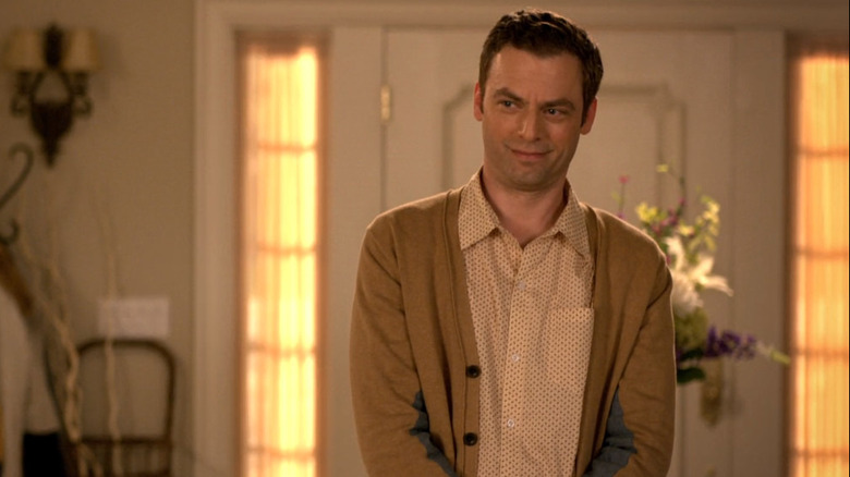 Andy in cardigan smirking