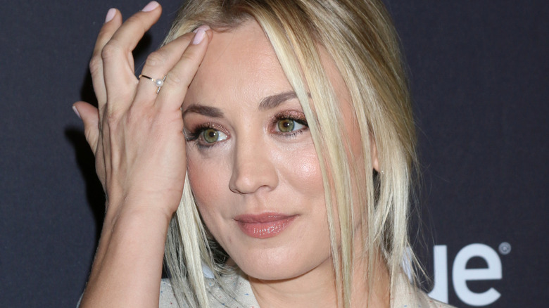 Kaley Cuoco moving her hair from her face