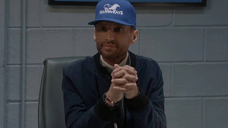 Coach Montes wears a baseball cap in "All American" (2022-2023)