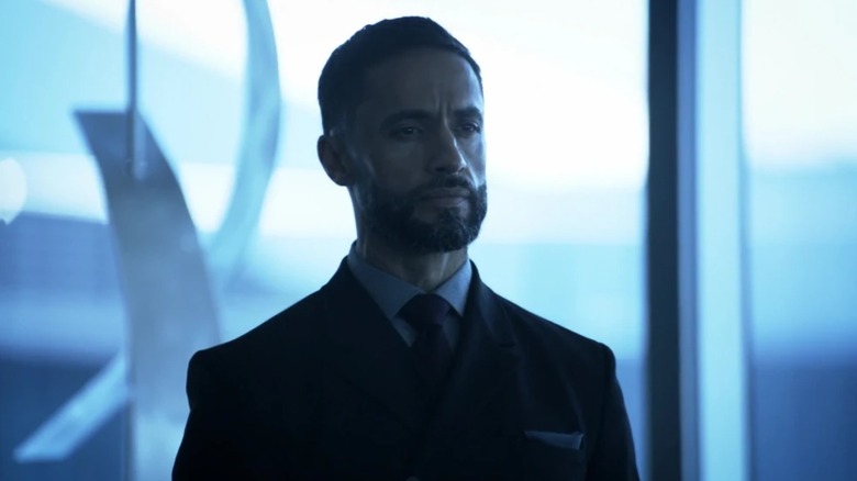 Jobe wearing a black suit in front of a window in "Sleepy Hollow" (2017)