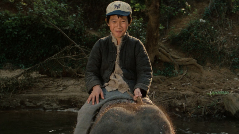 Short Round riding a small elephant in Temple of Doom