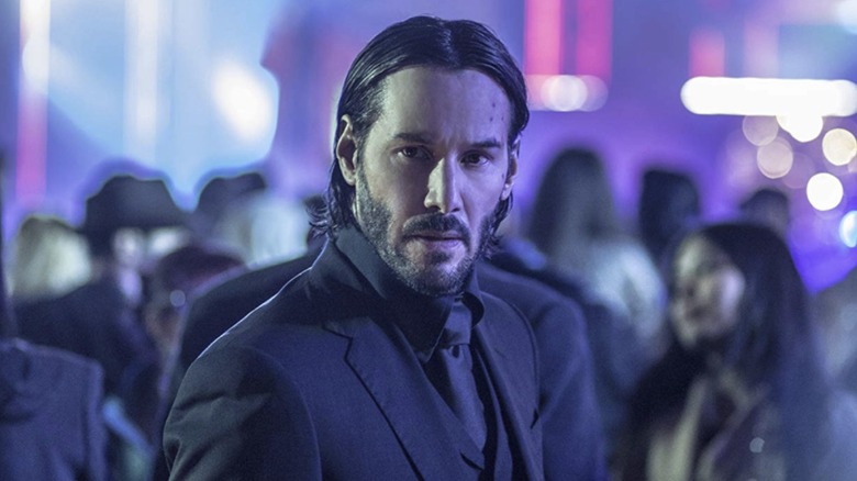 John Wick looking serious in a nightclub