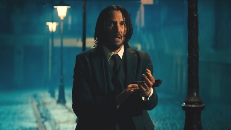 John Wick checks his gun