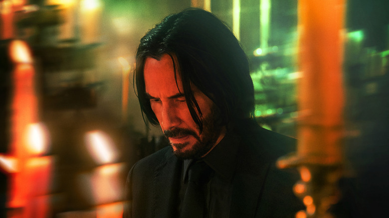 John Wick with head bowed