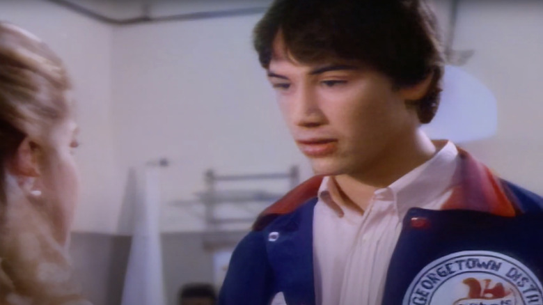 Michael Riley wearing red and blue jacket
