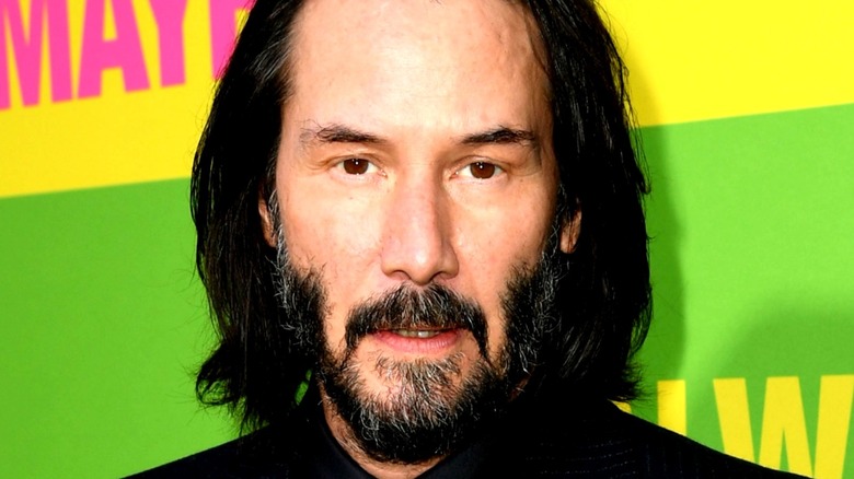Keanu Reeves poses for a photo