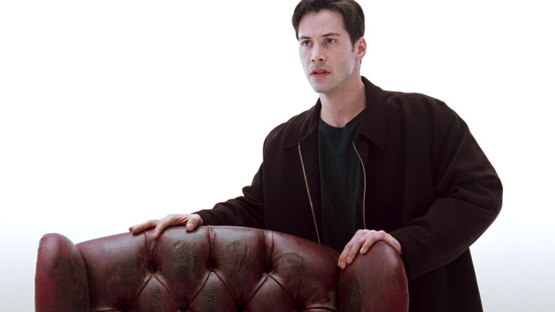 Neo holding a chair