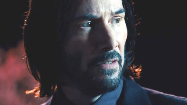 John Wick wearing a black blazer and collared shirt