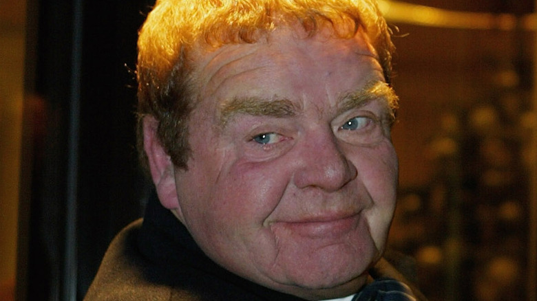 Geoffrey Hughes smiles