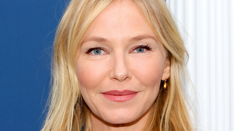 Kelli Giddish smirks slightly