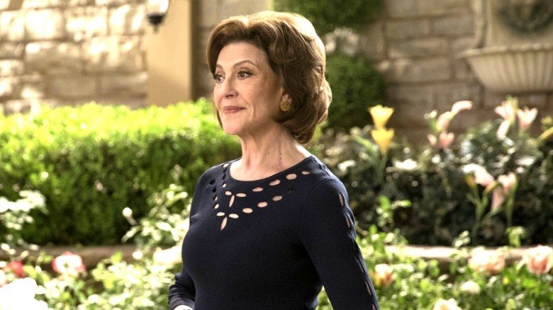 Emily Gilmore standing in the courtyard