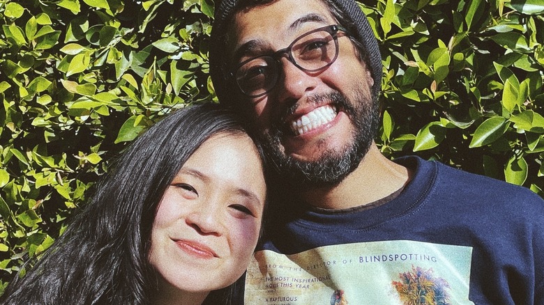 Kelly Marie Tran and Carlos Lopez Estrada smililng 