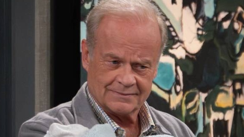 Frasier Crane holding a baby