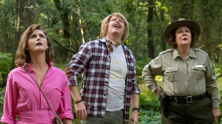 Keri Russell, Jesse Tyler Ferguson, and Margo Martindale looking up in "Cocaine Bear"