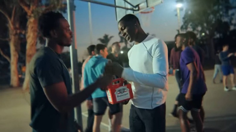 Two men sharing a Budweiser