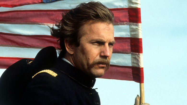 Costner holds an American flag