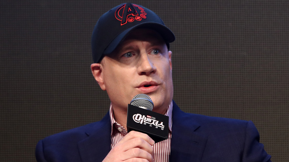 Kevin Feige holding microphone