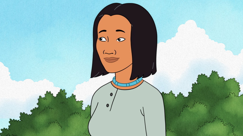 Connie Souphanousinphone smiling in front of some trees