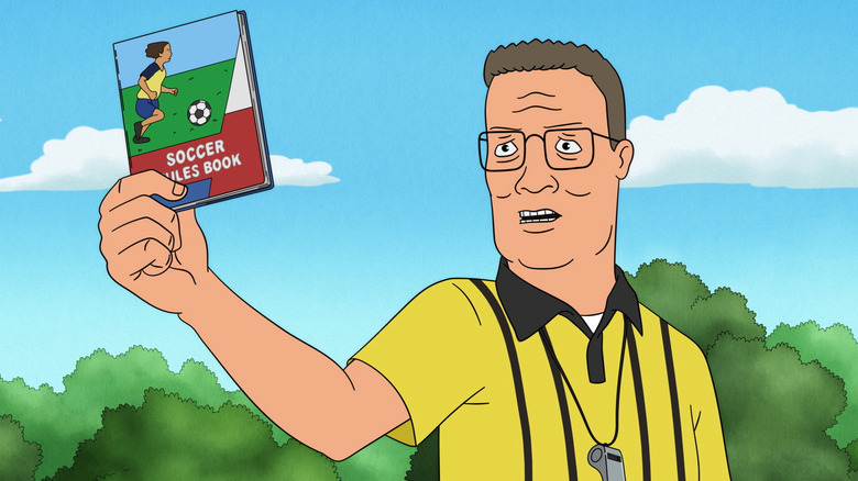 Hank Hill brandishes a soccer manual in "King of the Hill"