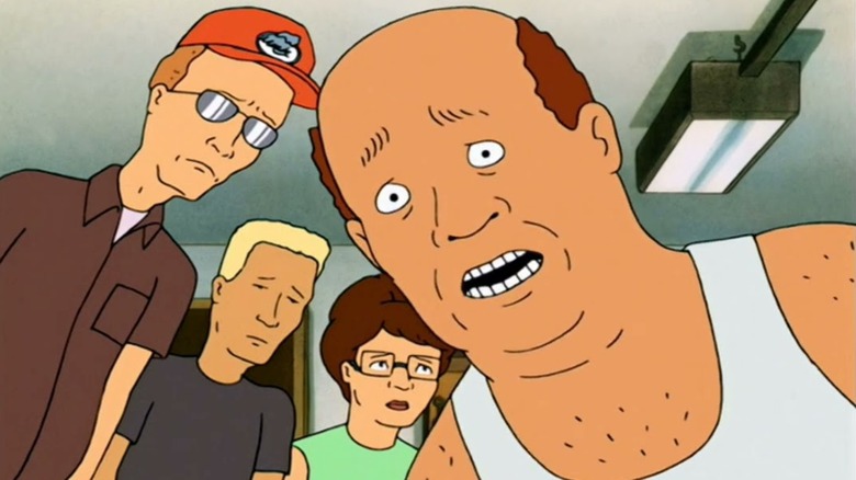 Hank's friends look down at him after he's been kicked by Bobby in 