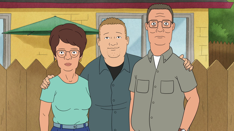 Hank, Peggy, and Bobby Hill posing for a photo by their fence (2025)