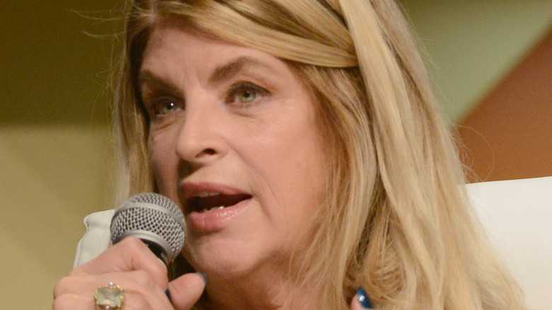 Kirstie Alley speaking into microphone