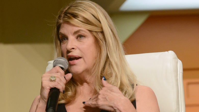 Kirstie Alley speaking into microphone
